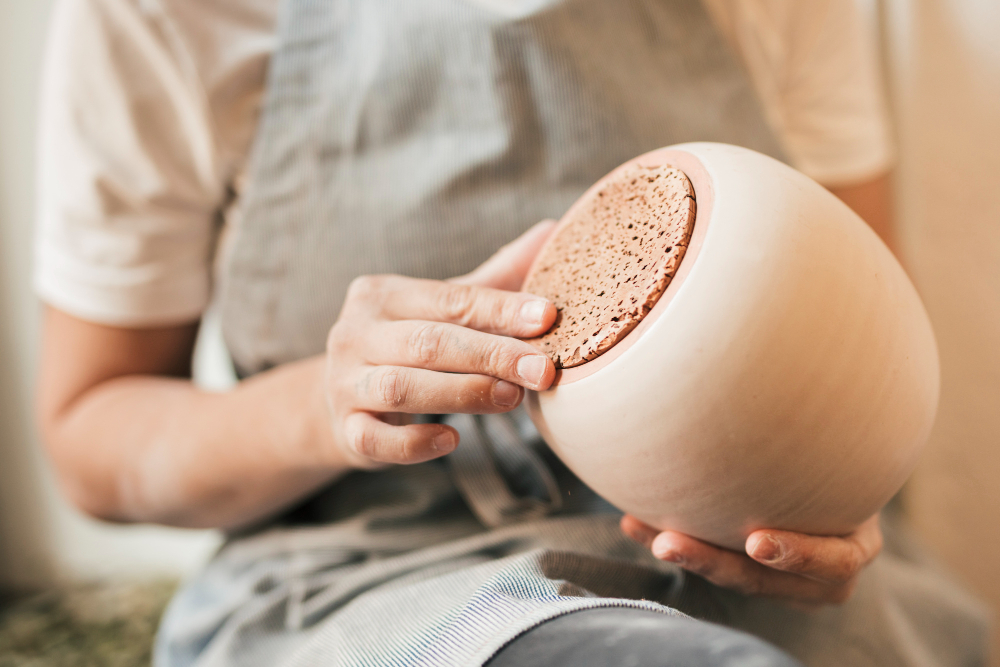 midsection-skilled-potter-holding-ceramic-pot-hand
